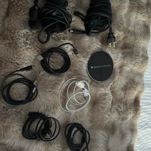 A bunch of computer, Apple Watch  and usb cords